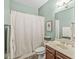 Clean bathroom with a shower and tub combination, vanity and framed mirror at 630 N College Ave # 204, Indianapolis, IN 46204