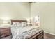 Bedroom with a large window, wood floors and an ensuite bathroom at 630 N College Ave # 204, Indianapolis, IN 46204