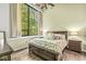 Bedroom with a large window and wood floors at 630 N College Ave # 204, Indianapolis, IN 46204