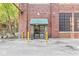 Charming building entrance with modern glass doors and a green awning at 630 N College Ave # 204, Indianapolis, IN 46204