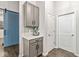 Butler pantry with gray cabinets, counter appliance, and sliding barn door at 630 N College Ave # 204, Indianapolis, IN 46204