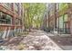 Outdoor courtyard area with brick buildings, trees, picnic tables, and pavers at 630 N College Ave # 204, Indianapolis, IN 46204