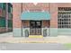 Building entrance with a green awning and double doors at 630 N College Ave # 204, Indianapolis, IN 46204