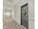 Long hallway with doors and patterned carpet at 630 N College Ave # 204, Indianapolis, IN 46204