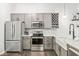 Modern kitchen with stainless steel appliances and gray cabinets at 630 N College Ave # 204, Indianapolis, IN 46204
