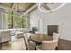 Living room with large windows, exposed ductwork, wood beams, and hardwood floors at 630 N College Ave # 204, Indianapolis, IN 46204