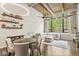Bright living room with exposed ductwork and beams, large windows, and elegant furniture at 630 N College Ave # 204, Indianapolis, IN 46204