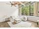 Inviting living room featuring exposed ductwork, wood beams, and a large window at 630 N College Ave # 204, Indianapolis, IN 46204