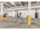 Indoor parking garage area with concrete pillars, open parking spots, and a small tree at 630 N College Ave # 204, Indianapolis, IN 46204