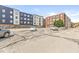 Outdoor parking lot view with multiple cars parked in front of buildings at 630 N College Ave # 204, Indianapolis, IN 46204
