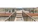 Exterior access to the roof deck with steps, railings and stone below at 630 N College Ave # 204, Indianapolis, IN 46204