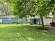 Charming blue brick ranch home featuring an attached garage and well-manicured front lawn at 7103 E Wiser Ave, Camby, IN 46113
