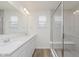Bright bathroom with double sinks, large mirror, and spacious glass shower at 7330 Shroyer Way, Noblesville, IN 46062