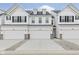 Charming white townhome with a two-car garage and beautifully designed exterior features at 7330 Shroyer Way, Noblesville, IN 46062