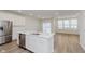 Bright kitchen with stainless steel appliances and a view into the sunny dining area at 7330 Shroyer Way, Noblesville, IN 46062