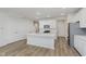 Well-lit kitchen with white cabinets, island, and stainless steel appliances at 7330 Shroyer Way, Noblesville, IN 46062