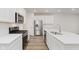 Modern kitchen with white cabinets, stainless steel appliances, and a large center island at 7330 Shroyer Way, Noblesville, IN 46062