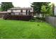 Backyard view featuring a large lawn, wooden deck attached to house, and privacy fence at 7402 Broadview Dr, Indianapolis, IN 46227