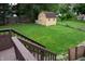 The expansive backyard featuring a large, well-maintained lawn and a storage shed at 7402 Broadview Dr, Indianapolis, IN 46227