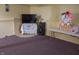 The basement area features an entertainment area with a television and a small table at 7402 Broadview Dr, Indianapolis, IN 46227
