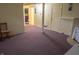 Spacious basement featuring access to other rooms, painted cinderblock walls, and carpet flooring at 7402 Broadview Dr, Indianapolis, IN 46227