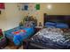 Shared bedroom with twin beds, dark furniture, and colorful bedding and decorative drawings on the walls at 7402 Broadview Dr, Indianapolis, IN 46227