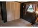 Bedroom featuring a closet, window, carpet, and dark walls, with light pouring in for a cozy and peaceful room at 7402 Broadview Dr, Indianapolis, IN 46227