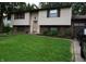 Split-level home featuring neutral siding, brick accents, and a well-maintained green lawn at 7402 Broadview Dr, Indianapolis, IN 46227