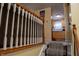 Stairway leading from one level to another. Decorative white rails and wooden handrail at 7402 Broadview Dr, Indianapolis, IN 46227