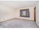 Spacious bedroom with neutral carpet, curtains, baseboards and trim at 7418 Southern Lakes Dr, Indianapolis, IN 46237