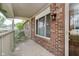A lovely brick front porch features a large window and a wooden front door at 7418 Southern Lakes Dr, Indianapolis, IN 46237