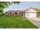 Charming single-story home with a well-maintained lawn and inviting front porch at 7418 Southern Lakes Dr, Indianapolis, IN 46237