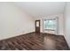 Bright living room with wood-look floors and a large window at 7418 Southern Lakes Dr, Indianapolis, IN 46237