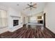 Bright living room featuring a painted brick fireplace and wood-look floors at 7418 Southern Lakes Dr, Indianapolis, IN 46237