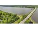 Scenic aerial view of the area, featuring the road, lake, and surrounding nature at 7426 Shadow Wood Dr, Indianapolis, IN 46254