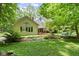 Picturesque home exterior featuring a well-maintained lawn and mature trees for privacy at 7426 Shadow Wood Dr, Indianapolis, IN 46254
