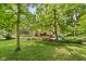 Lush backyard showcasing mature trees and manicured landscaping at 7426 Shadow Wood Dr, Indianapolis, IN 46254