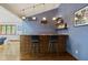 A stylish bar area with tile accents, shelving, and hardwood floors at 7426 Shadow Wood Dr, Indianapolis, IN 46254