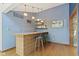 Charming bar area with tile accents, shelving, and hardwood floors at 7426 Shadow Wood Dr, Indianapolis, IN 46254