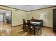 This dining room features hardwood floors, a glass table, and modern chandelier at 7426 Shadow Wood Dr, Indianapolis, IN 46254