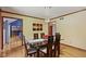 Cozy dining room with hardwood floors, stylish lighting, and an open view to other rooms at 7426 Shadow Wood Dr, Indianapolis, IN 46254