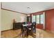 Formal dining room with hardwood floors, chandelier, and a large window for natural light at 7426 Shadow Wood Dr, Indianapolis, IN 46254