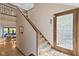 Entryway features a staircase, tile floor, a wood door, and glimpses into the living space at 7426 Shadow Wood Dr, Indianapolis, IN 46254