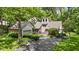 Charming home with well-kept lawn, brick accents, and a paved driveway in a tranquil setting at 7426 Shadow Wood Dr, Indianapolis, IN 46254