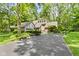 Attractive home with a long driveway, brick details, and verdant surroundings at 7426 Shadow Wood Dr, Indianapolis, IN 46254