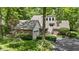 Brick home featuring an attached garage, manicured lawn, and lush landscaping at 7426 Shadow Wood Dr, Indianapolis, IN 46254