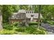 Brick home featuring an attached garage, manicured lawn, and lush landscaping at 7426 Shadow Wood Dr, Indianapolis, IN 46254