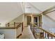 Hallway with wood banister and grey carpet that has several rooms leading off of it at 7426 Shadow Wood Dr, Indianapolis, IN 46254
