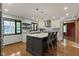 Newly remodeled kitchen features a central island with seating, stainless appliances, granite tops, and wooden floors at 7426 Shadow Wood Dr, Indianapolis, IN 46254