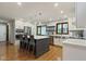 A modern kitchen with a large island, stainless steel appliances, hardwood floors, and white cabinets at 7426 Shadow Wood Dr, Indianapolis, IN 46254
